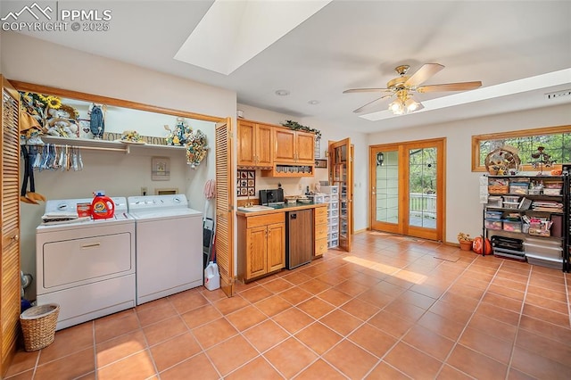 435 W Woodmen Rd, Colorado Springs, CO 80919 - kitchen featuring washing machine and clothes dryer, light tile patterned floors, light countertops, ceiling fan, and a skylight