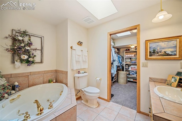 435 W Woodmen Rd, Colorado Springs, CO 80919 - bathroom with a skylight, a whirlpool tub, toilet, tile patterned floors, and vanity