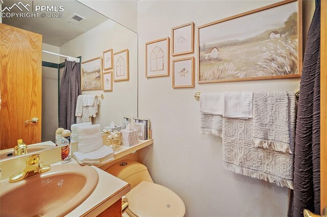 435 W Woodmen Rd, Colorado Springs, CO 80919 - bathroom with toilet, vanity, and a shower with shower curtain