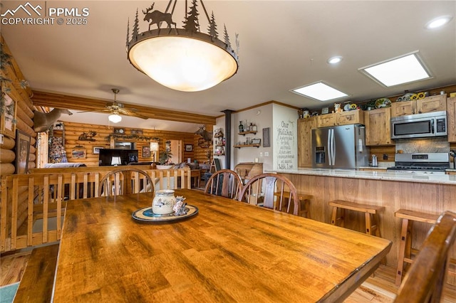 1369 Spring Valley Dr, Divide, CO 80814 - dining room featuring log walls, wood finished floors, ornamental molding, and ceiling fan