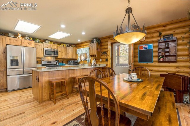 1369 Spring Valley Dr, Divide, CO 80814 - dining room with rustic walls, light wood finished floors, and recessed lighting