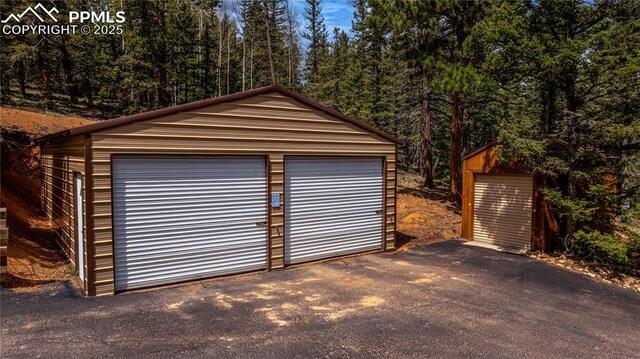 1369 Spring Valley Dr, Divide, CO 80814 - detached garage with a wooded view