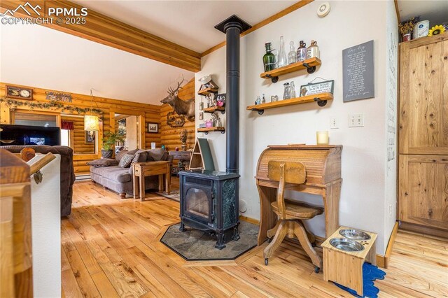1369 Spring Valley Dr, Divide, CO 80814 - living room with a wood stove, wood-type flooring, beam ceiling, and log walls