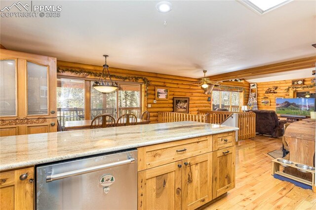 1369 Spring Valley Dr, Divide, CO 80814 - kitchen featuring dishwasher, rustic walls, light wood-style flooring, hanging light fixtures, and open floor plan