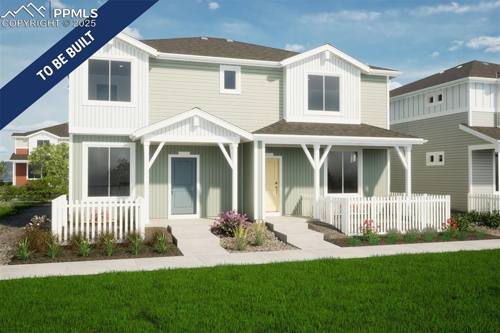 5831 Uptop Pt, Colorado Springs, CO 80927 - rear view of house featuring board and batten siding, covered porch, roof with shingles, and a lawn