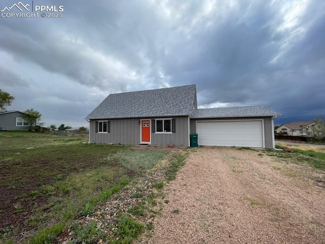 10910 Double D Rd, Fountain, CO 80817 - view of front facade featuring dirt driveway and an attached garage