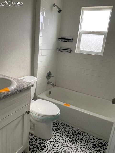 10910 Double D Rd, Fountain, CO 80817 - full bath featuring vanity, tile patterned flooring, shower / bathtub combination, and toilet