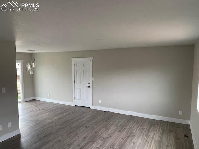 10910 Double D Rd, Fountain, CO 80817 - empty room with dark wood-type flooring and baseboards