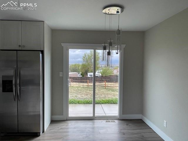 10910 Double D Rd, Fountain, CO 80817 - unfurnished dining area featuring baseboards and light wood finished floors