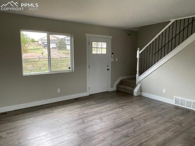 10910 Double D Rd, Fountain, CO 80817 - foyer entrance featuring stairs, baseboards, and wood finished floors