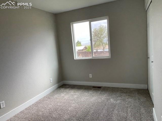 10910 Double D Rd, Fountain, CO 80817 - carpeted empty room with baseboards