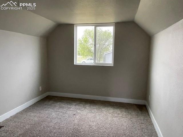 10910 Double D Rd, Fountain, CO 80817 - additional living space with vaulted ceiling, carpet flooring, and baseboards
