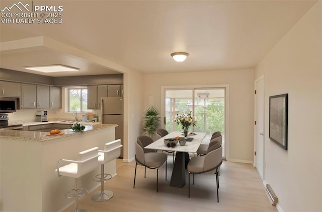 1934 Berkshire Ln, Colorado Springs, CO 80909 - dining space featuring light wood-type flooring and baseboards