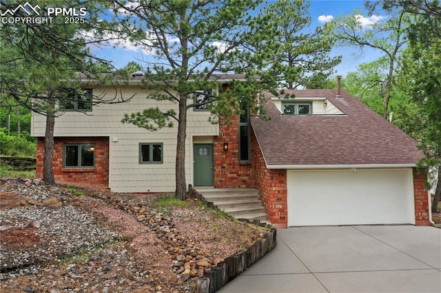 595 Wintery Cir, Colorado Springs, CO 80919 - view of front of house with concrete driveway, a shingled roof, and brick siding