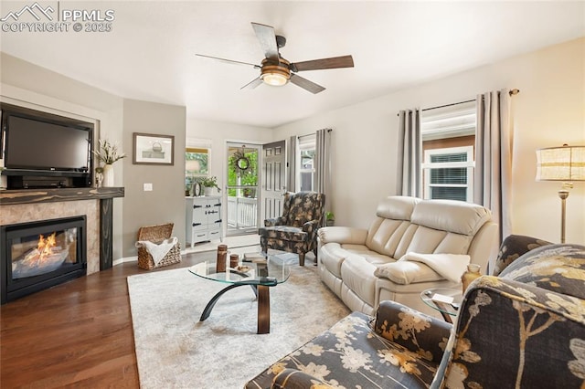7833 Bengali Ln, Colorado Springs, CO 80923 - living room with wood finished floors, ceiling fan, and a tile fireplace