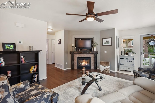 7833 Bengali Ln, Colorado Springs, CO 80923 - living area featuring ceiling fan, a tile fireplace, wood finished floors, and baseboards