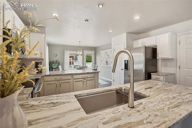 7833 Bengali Ln, Colorado Springs, CO 80923 - kitchen featuring stainless steel fridge with ice dispenser, light stone countertops, white cabinets, and recessed lighting