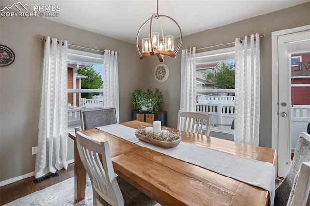 7833 Bengali Ln, Colorado Springs, CO 80923 - dining area featuring wood finished floors, plenty of natural light, a chandelier, and baseboards
