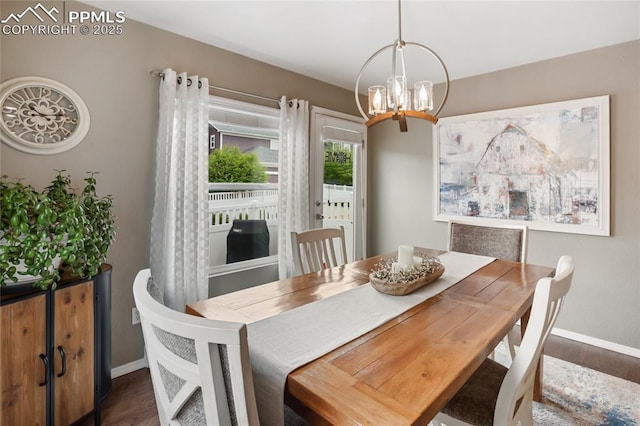 7833 Bengali Ln, Colorado Springs, CO 80923 - dining room featuring wood finished floors, baseboards, and a chandelier