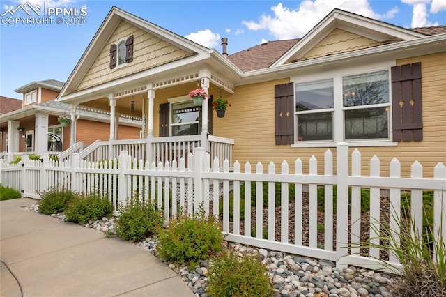 7833 Bengali Ln, Colorado Springs, CO 80923 - victorian-style house featuring a porch and a fenced front yard