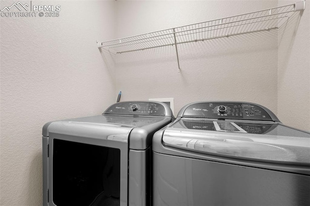 7856 Calabash Rd, Colorado Springs, CO 80908 - laundry area with separate washer and dryer and a textured wall
