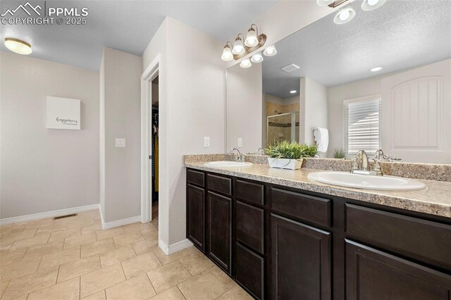 7856 Calabash Rd, Colorado Springs, CO 80908 - full bathroom featuring double vanity, a shower stall, and a spacious closet