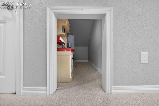 7856 Calabash Rd, Colorado Springs, CO 80908 - hall with carpet floors, lofted ceiling, and a textured wall