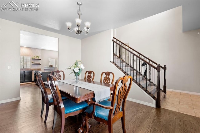 7856 Calabash Rd, Colorado Springs, CO 80908 - dining space with a chandelier, stairway, and wood finished floors