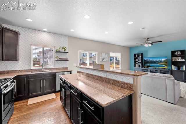 7856 Calabash Rd, Colorado Springs, CO 80908 - kitchen featuring stainless steel range with gas cooktop, plenty of natural light, dishwasher, a center island, and recessed lighting