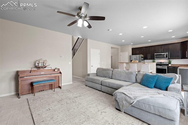 7856 Calabash Rd, Colorado Springs, CO 80908 - living area featuring light carpet, recessed lighting, a ceiling fan, and stairs