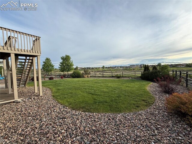 10402 Capital Peak Way, Peyton, CO 80831 - view of yard with stairs, a wooden deck, and a rural view