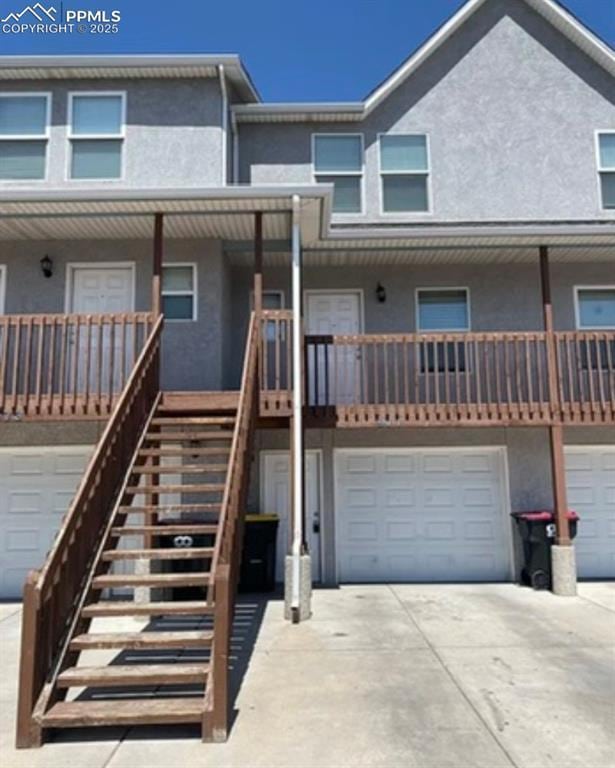 967 Brant Hollow Ct, Colorado Springs, CO 80916 - multi unit property featuring stucco siding, driveway, an attached garage, and stairway