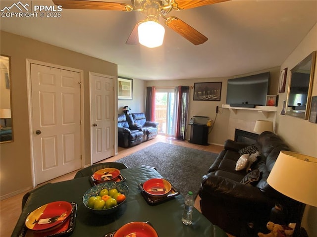 967 Brant Hollow Ct, Colorado Springs, CO 80916 - living area with ceiling fan, baseboards, a glass covered fireplace, and wood finished floors