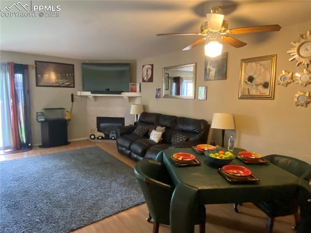 967 Brant Hollow Ct, Colorado Springs, CO 80916 - living room with healthy amount of natural light, wood finished floors, ceiling fan, and a fireplace