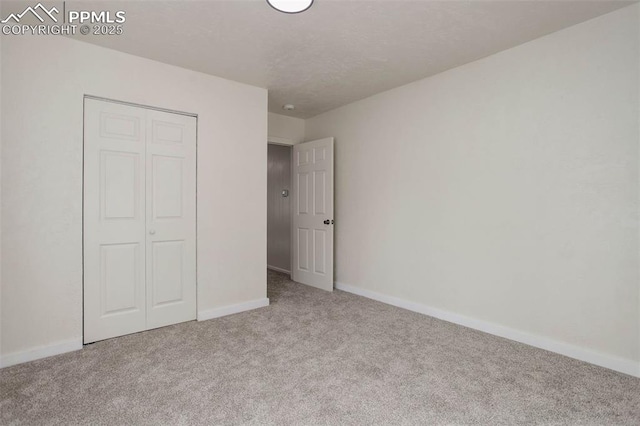 1567 Willshire Dr, Colorado Springs, CO 80906 - unfurnished bedroom featuring carpet flooring, a closet, baseboards, and a textured ceiling