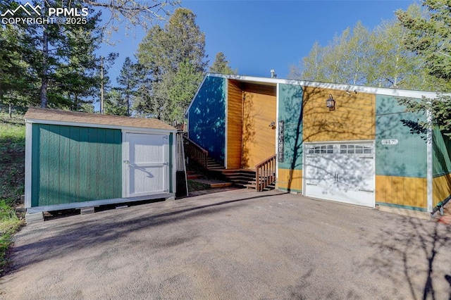 417 W Columbine Ave, Woodland Park, CO 80863 - view of shed with driveway and a garage