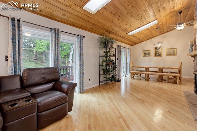 417 W Columbine Ave, Woodland Park, CO 80863 - living room with lofted ceiling, wooden ceiling, a skylight, baseboards, and healthy amount of natural light