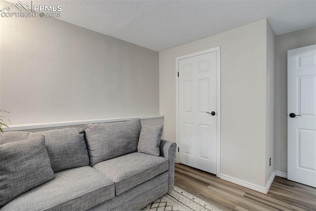 417 W Columbine Ave, Woodland Park, CO 80863 - sitting room with wood finished floors, baseboards, and a textured ceiling