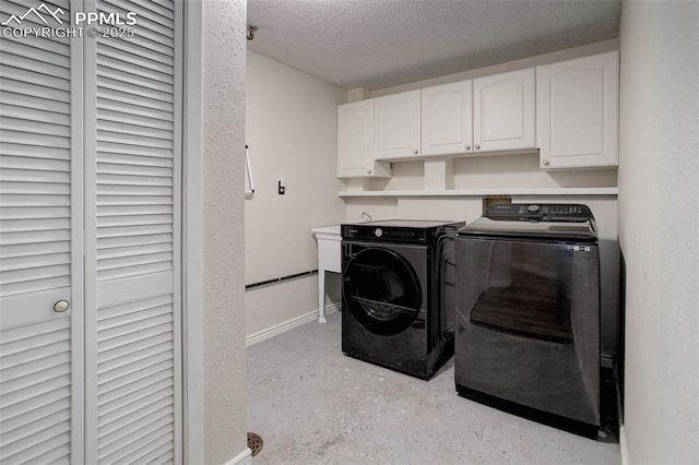 417 W Columbine Ave, Woodland Park, CO 80863 - laundry room with washing machine and clothes dryer, cabinet space, a textured ceiling, and baseboards