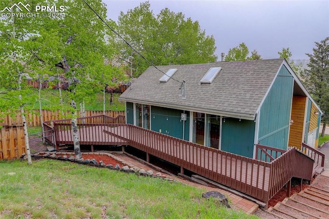 417 W Columbine Ave, Woodland Park, CO 80863 - back of property with roof with shingles and a wooden deck