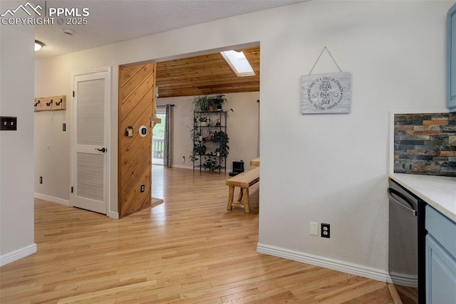 417 W Columbine Ave, Woodland Park, CO 80863 - hall with a skylight, baseboards, light wood finished floors, and vaulted ceiling