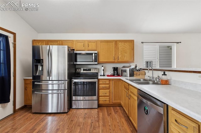5630 Almont Ave, Colorado Springs, CO 80911 - kitchen with stainless steel appliances, a sink, light countertops, and wood finished floors