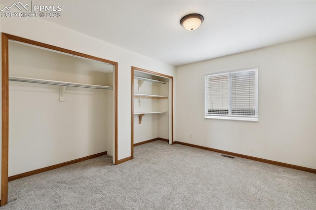 5630 Almont Ave, Colorado Springs, CO 80911 - unfurnished bedroom featuring carpet flooring, two closets, and baseboards