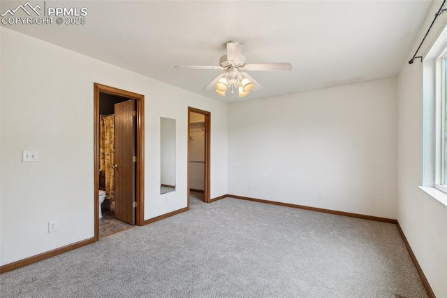 5630 Almont Ave, Colorado Springs, CO 80911 - unfurnished bedroom with carpet floors, a walk in closet, baseboards, and multiple windows