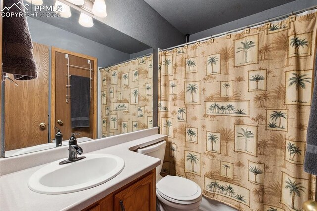 5630 Almont Ave, Colorado Springs, CO 80911 - bathroom featuring toilet, vanity, and a shower with shower curtain