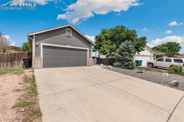 5630 Almont Ave, Colorado Springs, CO 80911 - ranch-style house with brick siding, a garage, and driveway