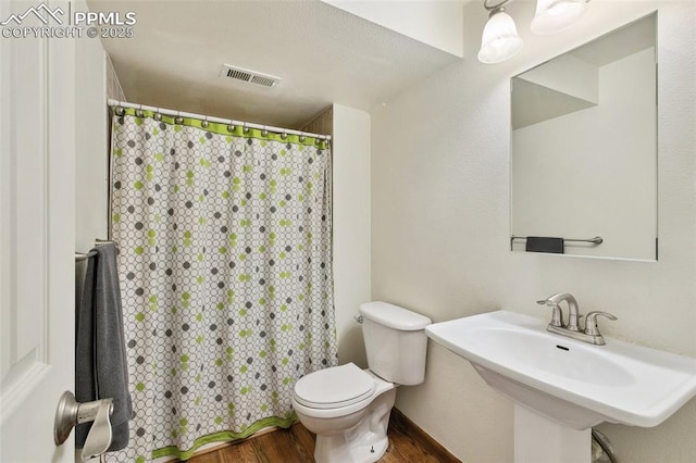 5630 Almont Ave, Colorado Springs, CO 80911 - full bath with wood finished floors, toilet, a shower with curtain, and a sink