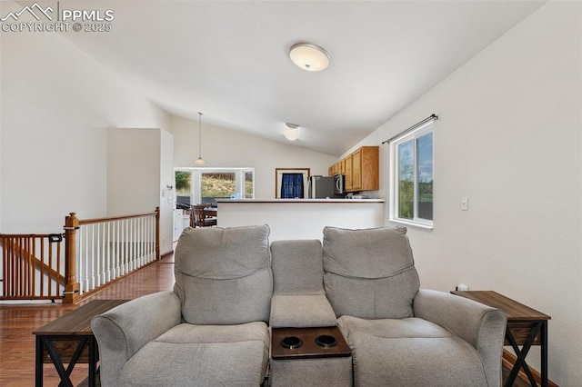 5630 Almont Ave, Colorado Springs, CO 80911 - living area featuring vaulted ceiling, wood finished floors, and healthy amount of natural light