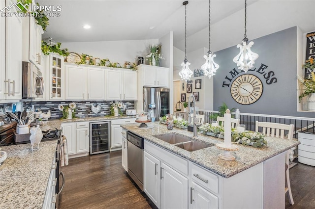 7198 Bigtooth Maple Dr, Colorado Springs, CO 80925 - kitchen with stainless steel appliances, wine cooler, a sink, backsplash, and white cabinetry