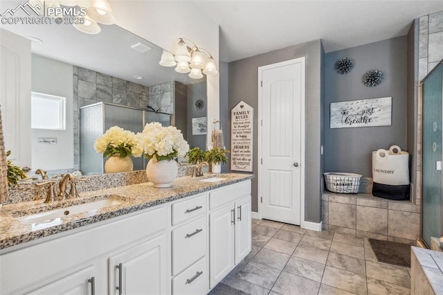 7198 Bigtooth Maple Dr, Colorado Springs, CO 80925 - full bath featuring double vanity, a stall shower, baseboards, and tile patterned flooring